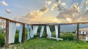 a view from the backyard of a house with white curtains at ENTRESIERRAS Apartamentos rurales piscina 24h con barbacoa y espacio para eventos in Cazorla