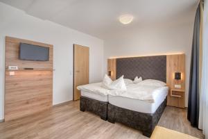 Postel nebo postele na pokoji v ubytování Hotel Wiehen-Therme