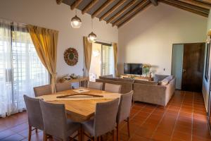 a dining room with a table and a couch at Casa Oseleta de Bodega Masi in Tupungato