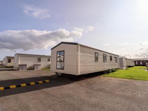 a tiny house is parked in a parking lot at Beachcomber D35 in Abergele