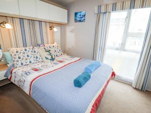 a bedroom with a bed with a blue object on it at Beachcomber D35 in Abergele