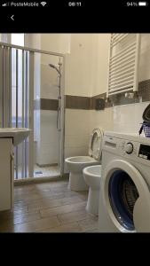 a bathroom with a washing machine and a toilet at Colibrì Apartment in Rome