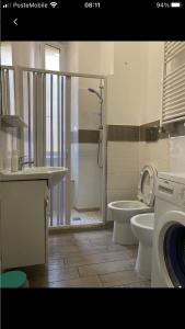 a bathroom with a shower and a toilet and a sink at Colibrì Apartment in Rome +24 photos