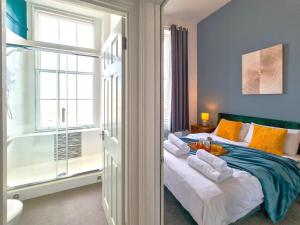 a bedroom with a bed and a window at Margaret's Terrace in Cheltenham