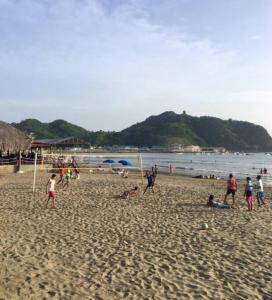 a group of people playing soccer on a beach at Modern Studio/Apt overlooking Pool/Ocean view in San Juan del Sur