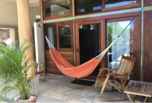 a hammock hanging from the side of a house at Modern Studio/Apt overlooking Pool/Ocean view in San Juan del Sur