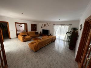a living room with two couches and a television at Villa Savanna in Cala en Blanes