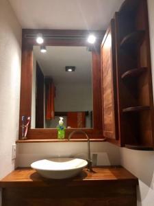 a bathroom with a sink and a mirror at Modern Studio/Apt overlooking Pool/Ocean view in San Juan del Sur