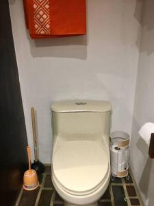 a bathroom with a white toilet in a room at Modern Studio/Apt overlooking Pool/Ocean view in San Juan del Sur