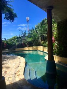 a swimming pool in the middle of a yard at Modern Studio/Apt overlooking Pool/Ocean view in San Juan del Sur