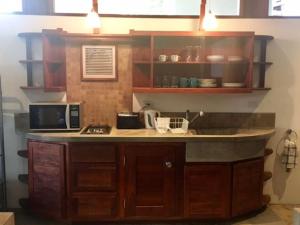 a kitchen with a counter top with a microwave at Modern Studio/Apt overlooking Pool/Ocean view in San Juan del Sur