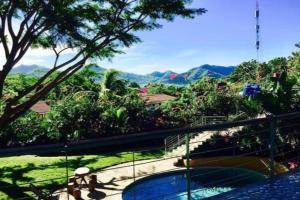 a resort with a view of the mountains at Modern Studio/Apt overlooking Pool/Ocean view in San Juan del Sur