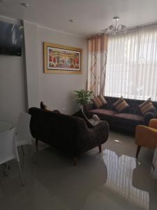 a living room with a couch and a table at LA FAMILIA NASCA HOUSE in Nazca