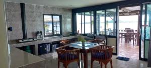 a kitchen and dining room with a table and chairs at Aquablue Villa in Ko Lanta