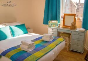 a bedroom with a bed with towels on it at Linton in Kinghorn