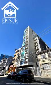 a building with a car parked in front of it at EBISUR Apart - Hoteles MAIPU in Concepción