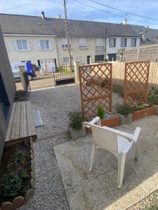 a patio with a bench and a wooden fence at Studio atypique Le Mans in Le Mans