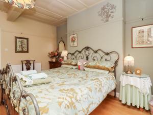 a bedroom with a large bed and a table at Oak Cottage in Skipton