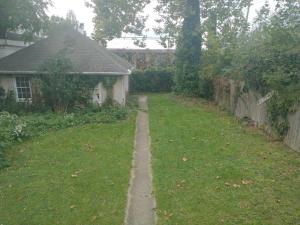 a backyard with a path in the grass at Blackjack's Bungalow in York