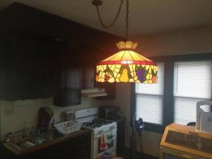 a kitchen with a stained glass light hanging from the ceiling at Blackjack's Bungalow in York