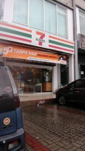 a car parked in front of a store on a street at RatuSpaQ Home Desaru Utama Residence Apartment in Bandar Penawar