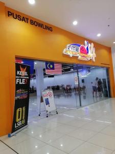 arusteat bowling gas station with a twistat bowling sign and people at RatuSpaQ Home Desaru Utama Residence Apartment in Bandar Penawar