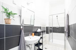 a bathroom with a sink and a shower at Jupiter Home Buda in Budapest +48 photos