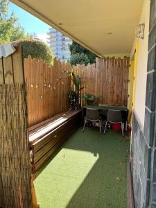 a backyard with a wooden fence and two chairs at Appartement T2 Bayonne-Anglet in Bayonne