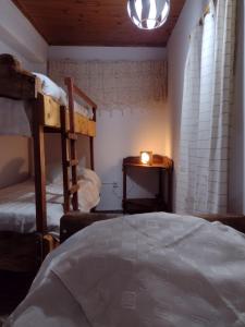 a bedroom with two bunk beds and a candle at Bov lavalle in San Rafael