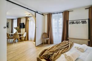 a bedroom with a bed and a table with chairs at Beautiful 2BDR near the Eiffel Tower in Paris