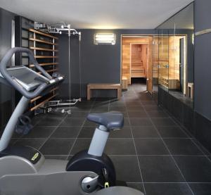 a gym with a treadmill and a chair in a room at Casa Camper Berlin in Berlin