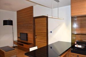 a living room with a tv and a glass wall at Royal Suites At Dua Sentral in Kuala Lumpur