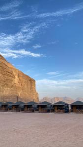 a building in the desert with a mountain in the background at Rest luxury camp in Disah