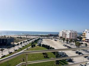 a view of a street with a beach and buildings at Caparica Ocean View in Costa da Caparica