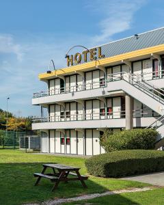 un hotel con un tavolo da picnic di fronte di Premiere Classe Bethune Fouquières Lès Béthunes a Fouquières-lès-Béthune