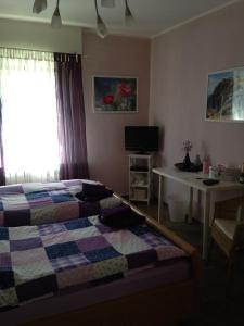 a bedroom with a bed and a table and a window at Haus Silbertal in Much