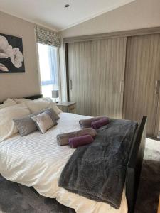 a bedroom with a large bed with pillows on it at Country Gem in Tydd Saint Giles +39 photos