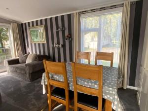 a living room with a table and chairs and a couch at Country Gem in Tydd Saint Giles