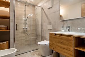 a bathroom with a shower and a toilet and a sink at Casa Caterina in Vigo di Fassa +22 photos