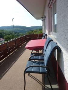 una mesa y sillas en el balcón de un edificio en Haus Waldeck en Wald-Michelbach
