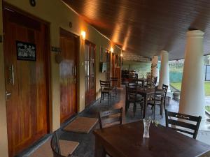 a dining room with tables and chairs in a restaurant at Eagles Eco Lodge - Kandy in Digana
