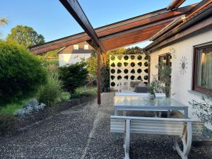 a patio with a table and a pergola at Ferienwohnung Renaissance in Backnang