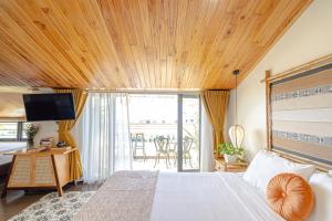a bedroom with a bed with a wooden ceiling at Virgo Villa Quê Hội An in Hoi An