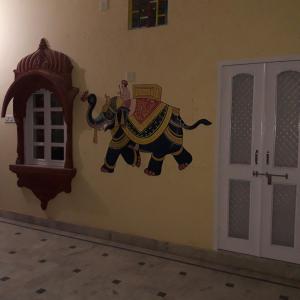 a painting of an elephant on the side of a wall at Desert Sun Homestay in Bikaner