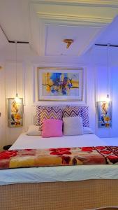 a bedroom with a large bed with two lights at Golden Aurora Lodge in Kumasi