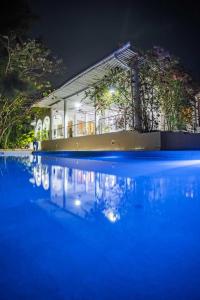 a building with a pool of water at night at Killi Luxury Villa in Moshi
