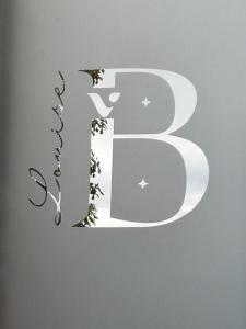 a letter b with a cut out design on a wall at VILLA LOUISE B, B comme Belle Epoque in Saint-Amand-les-Eaux