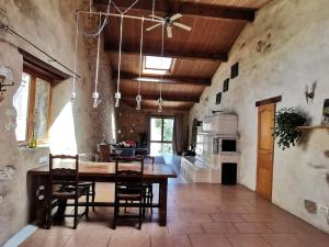 a large kitchen with a wooden table and chairs at Le gîte sylvestre, maison rurale in Saint-Jean-de-Paracol +27 photos