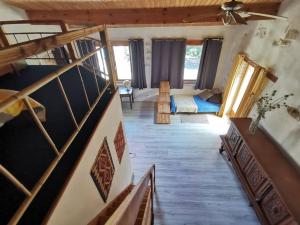a room with a staircase and a living room at Le gîte sylvestre, maison rurale in Saint-Jean-de-Paracol