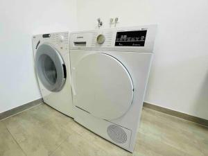 a white washing machine sitting in a room at SiOUX: Penthouse „BOHO“ mit traumhaftem Ausblick in Leutkirch im Allgäu